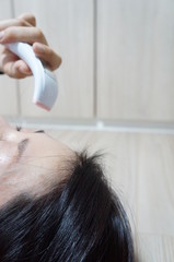 Fototapeta premium Daily temperature measurement is important to confirm the possibility of COVID-19 coronavirus infection.