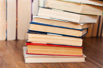 stack of old book on wooden table, education concept background, many books piles with copy space for text.