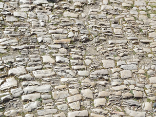 Texture of a shabby old pavement of cobblestones