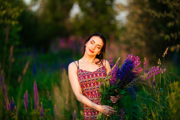 happy young girl smiling, holding hands in lavender. Soft focus, close-up