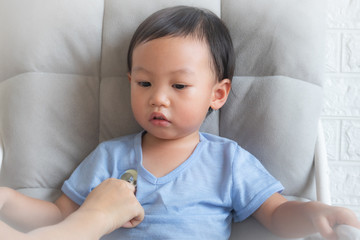 Little boy is examining by a doctor with stethoscope,Close-up of female pediatrician auscultating child's chest, Happy little boy having fun while is being examined by doctor by stethoscope,Sick child