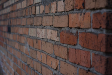 Brick masonry of bright red color in the form of a wall