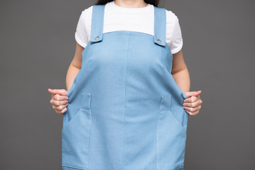 Girl in a large dress. Inappropriate size.
