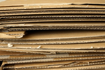 Close-up of stacked corrugated cardboard on white background.