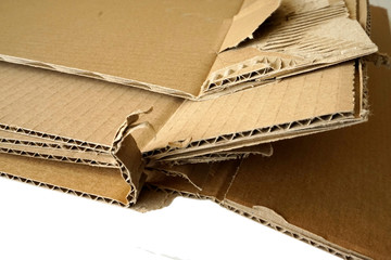 Close-up of stacked corrugated cardboard on white background.
