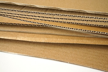 Close-up of stacked corrugated cardboard on white background.