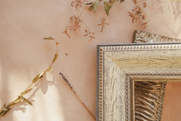 Empty photo frames on pastel canvas backdrop with dried flowers. Corners of picture frames. Cozy home decor.