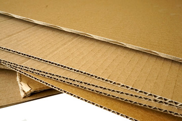 Close-up of stacked corrugated cardboard on white background.