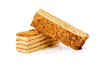 two pieces of layered honey cake isolated on white background