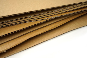 Close-up of stacked corrugated cardboard on white background.