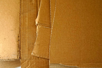 Close-up of stacked corrugated cardboard. Sheets of brown corrugated cardboard.
