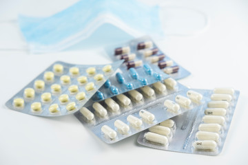 Pills and medical mask on white background. Coronavirus concept