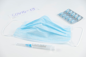Coronavirus prevention medicall masks, syringe and pills. Stop COVID-19
