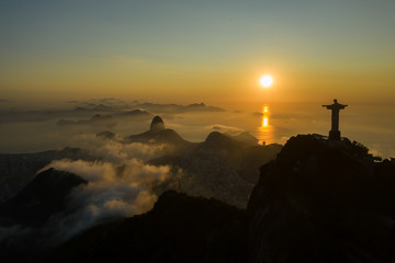 Drone, panoramic shot of a sunrise over Guanabara Bay with Christ the Redeemer statue in the foreground