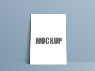 Blank white paper poster standing on floor. Poster mock-up template