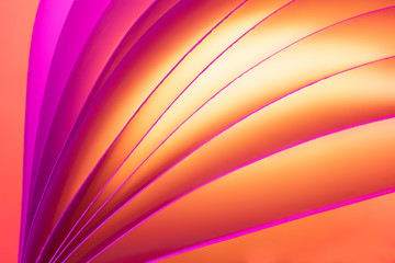 Macro photo. Abstract minimalistic background - paper art. Neon orange light, minimalism, copyspace. Waves, paper cut. 3D effect.
