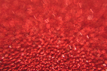 Abstract background and texture. Bright highlights on a red synthetic surface