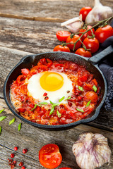 Shakshuka Scrambled eggs with tomatoes and vegetables. Breakfast. In the plate. Top view. Flat lay composition Free copy space.