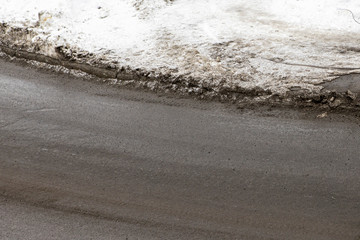 top view of the road and melted the snow on the sidewalk. The arrival of spring
