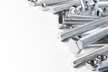 Lots of metal bolts and nuts. Tool for fixing. White background. Copy space