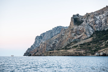 Fototapeta na wymiar ship in the sea near the mountain