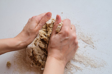 Woman hands kneading the dough. Flour on the wooden table. Preparing the dough for baking. Making homemade cuisine for family. Chef in the kitchen cooking pastry. Healthy delicious culinary recipe