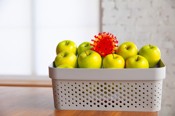 Coronavirus hiding in usual things - check cleanse and freshness of your fruits and food. One of the bunch. Apples, oranges, lemons on the kitchen's table. Pandemic, epidemic concept, disinfecting.