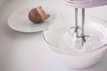 Whipped egg whites in a glass bowl