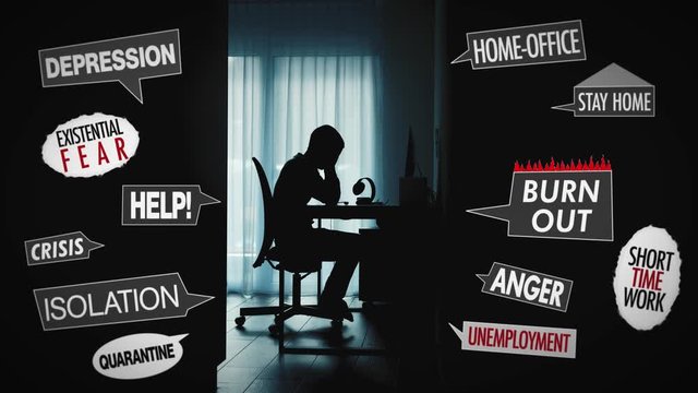 Silhouette shadow of a man at the computer in short time work at home office plagued by existential fears and anger about the situation. Keywords are shown. Depression, isolation, crisis, burnout.