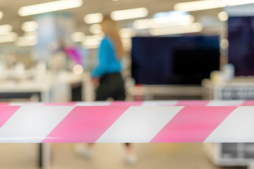 Closed appliance store with security tape in the foreground.