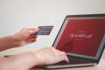 Hands holding credit card and use for shopping payment online on laptop, shopping online concept.