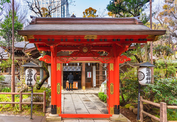 Red karamon gate decorated with the coat of arms of the Tokugawa shoguns in the Atago shrine on the highest mountain in Tokyo.