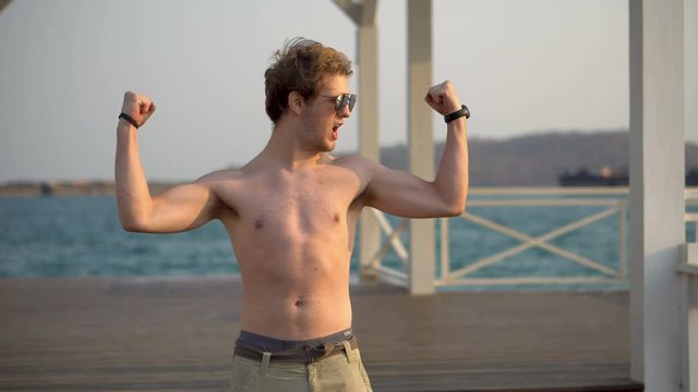 Fit Muscular Guy Flexing Muscles Outdoors