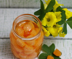 My grandmother's jam styling from yellow raspberries in a glass jar