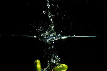 fresh starfruit water splash with black background