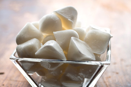 Coconut ice cubes in glass bowl