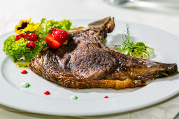 A delicious grilled beef steak with fresh salad. The food in the restaurant. Food styling and restaurant meal serving. Gourmet restaurant menu concept. Creative stylist restaurant