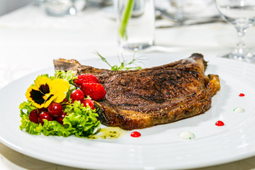 A delicious grilled beef steak with fresh salad. The food in the restaurant. Food styling and restaurant meal serving. Gourmet restaurant menu concept. Creative stylist restaurant