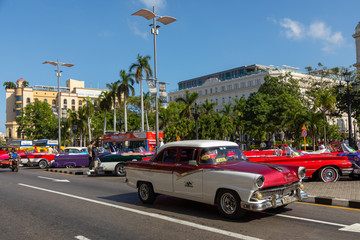 Havana Cuba Classic Cars. Typcal Havana urban scene with colorful buildings and old cars.