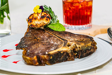 The food in the restaurant. Food styling and restaurant meal serving. Gourmet restaurant menu concept. Creative stylist restaurant T-bone steak on the plate