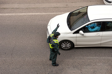 Guardia Civil stops a vehicle at a checkpoint during the Covid-19 pandemic - obrazy, fototapety, plakaty