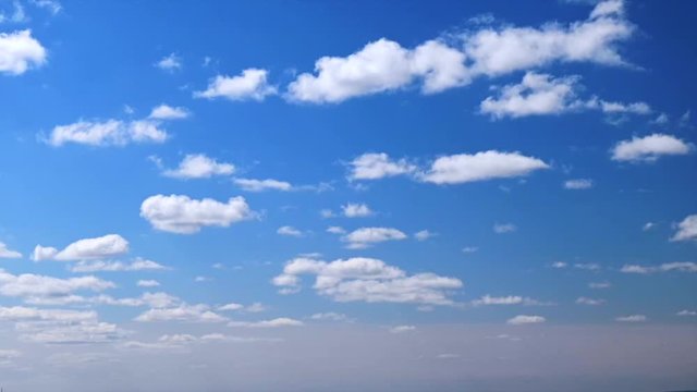 Timelapse with fast-running fluffy tiny white clouds on bright blue sky on a sunny summer day. 4K Time lapse puffy cloudy blue sky. Pattern of clouds in the sky. Texture. Nature. Air