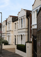 Typical houses for rich english persons. An unassailable alleyway near the famous part of London Wimbledon. Old-school architecture in Great Britain. Packed houses. Family houses for affluent people
