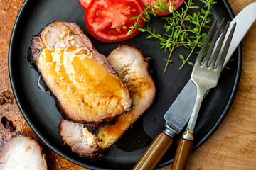 Overhead view of grilled pork loin slices on plate