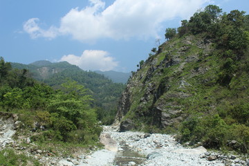 Fototapeta na wymiar View of dry river and green mountain