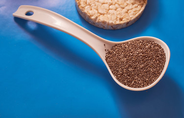 chia seeds in a spoon on a blue background