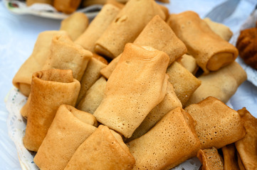 delicious fried pancakes stuffed on a plate. spring rolls with vegetables. pancakes at the festival Shrovetide