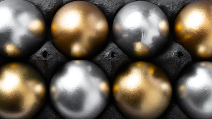 Background with golden and silver decorated easter eggs