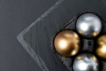 Background with golden and silver decorated easter eggs