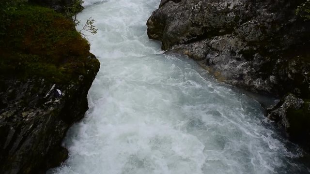 River which is located near path to the Briksdalsbreen (Briksdal) glacier. The melting of this glacier forms waterfall and river with clear water. Jostedalsbreen National Park. Norway.